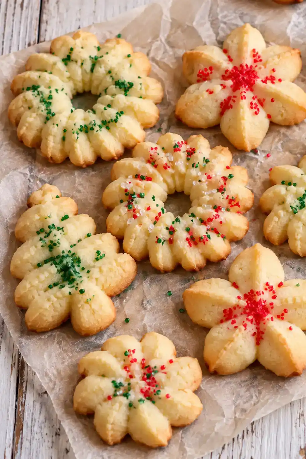 A batch of easy spritz cookies arranged on a ceramic plate.