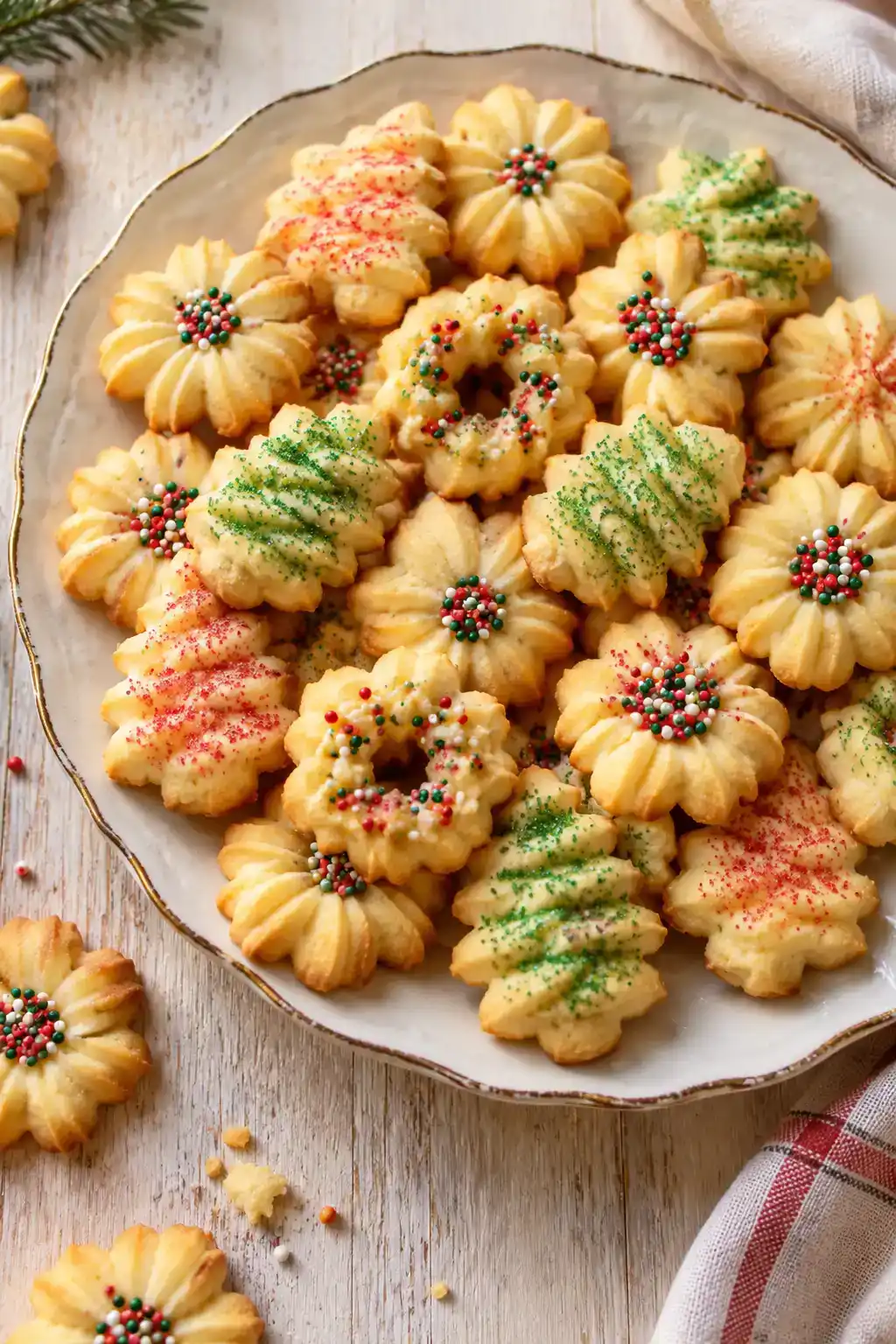 A batch of freezer-friendly spritz cookies arranged on a ceramic plate.