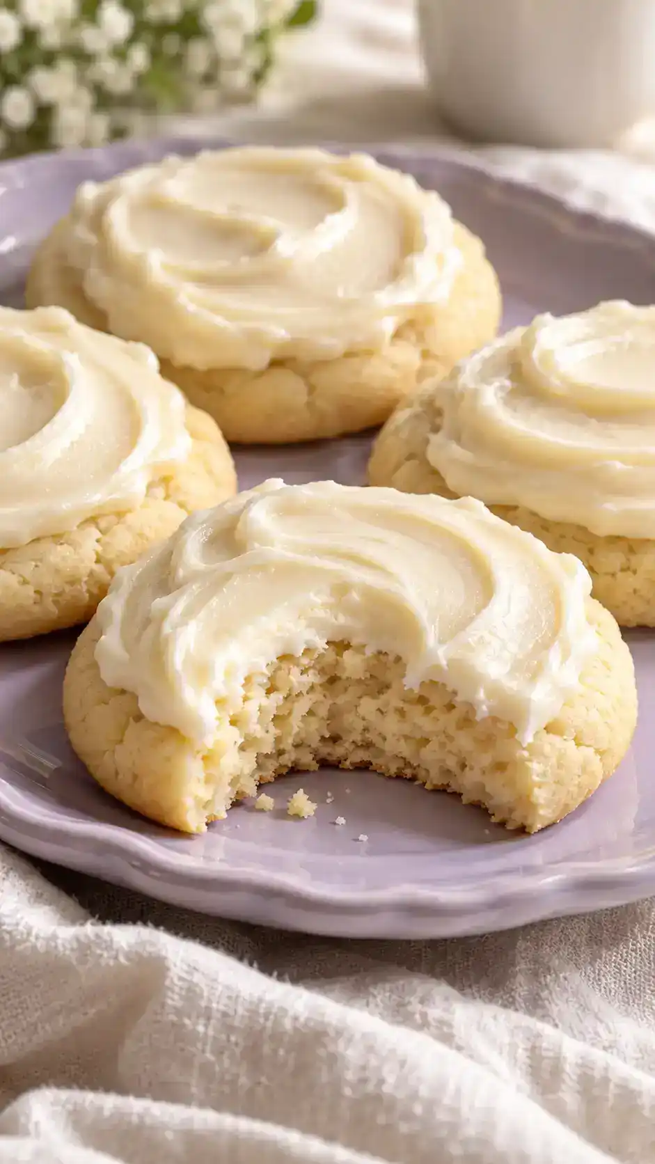Tender round cream-cheese sugar cookies with a creamy vanilla frosting swipe and a subtle tang.
