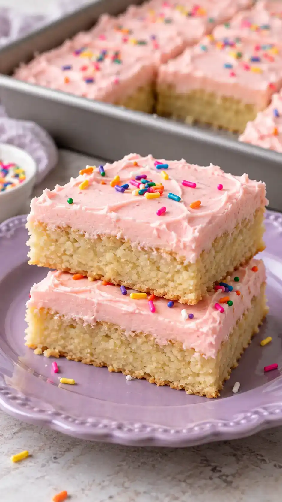 Soft vanilla sugar-cookie bars with a smooth cream-cheese frosting layer, cut into tidy party-ready squares.